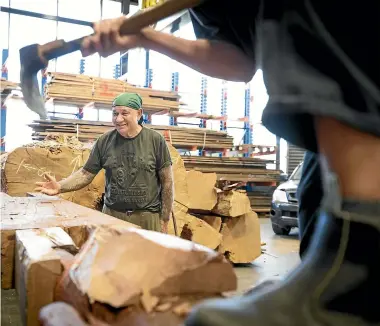  ?? KELLY HODEL/STUFF ?? Matua James Rickard watches on as a young carver chips away at the pou.