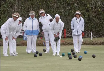  ??  ?? Bowlers keep a watchful eye on proceeding­s during the Inter Sub-districts bowling tournament.