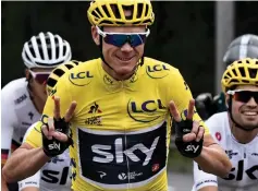  ?? — AFP photo ?? This file photo taken on July 23, 2017 shows Christophe­r Froome wearing the overall leader’s yellow jersey flashing victory sign next to Spain’s Mikel Landa during the 103 km twenty-first and last stage of the 104th edition of the Tour de France cycling race between Montgeron and Paris Champs-Elysees.