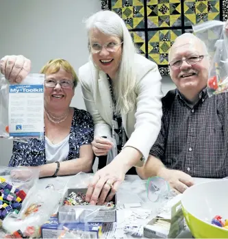  ?? CLIFFORD SKARSTEDT/EXAMINER ?? Volunteers Jim and Mary-Jane Rainey bag wellness tool kits with help from Roberta Herod of Herod Financial Services on Tuesday at the CMHA Kawartha Pine Ridge office on Water St. The idea for the new wellness tool kit came from one of their peer...