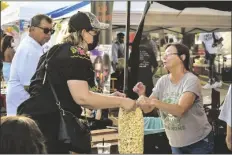  ?? ?? A customer purchases fresh kettle corn during Thursday’s 3rd annual Taco Festival in Brawley.