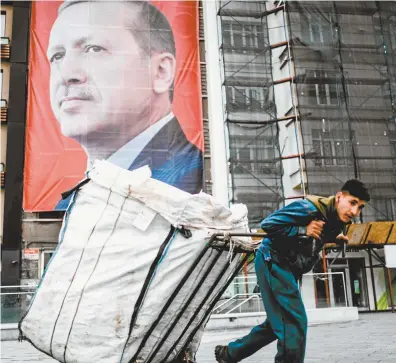  ??  ?? A huge portrait of Turkish president Recep Tayyip Erdoğan on the streets of Istanbul.