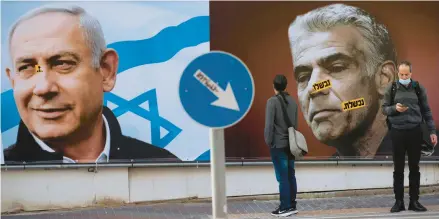  ?? ODED BALILTY/AP 2021 ?? A Likud campaign billboard in Ramat Gan, Israel, portrays party leader Benjamin Netanyahu, left, and Yesh Atid party leader Yair Lapid.