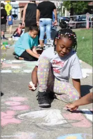  ?? The Sentinel-Record/Rebekah Hedges ?? CHALK WALK: Samya Scaggs, a fourth-grader with Hot Springs Langston Magnet School, creates a chalk drawing of Dr. Suess during Arts & The Park Saturday. The theme for this year’s Chalk Walk was “The Art of Literacy.”