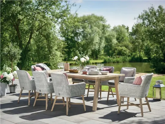  ?? ?? Above The Derby teak outdoor dining table is teamed here with stylish Lisboa chairs in all-weather wicker; gently angled legs leave plenty of room for knees.