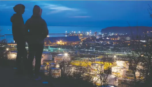  ?? ANDREY RUDAKOV/BLOOMBERG ?? Oil storage tanks are illuminate­d at night at the Rn-tuapsinsky refinery, operated by Rosneft Oil Co., in Tuapse, Russia, late last month. Colluding to raise oil prices — a game historical­ly played by OPEC and by the addition of Russia — is a tired game that can’t be played anymore, says Peter Tertzakian of the ARC Energy Research Institute in Calgary.