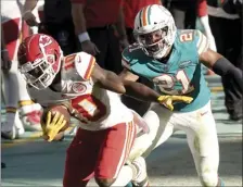  ?? AP photo ?? Chiefs receiver Tyreek Hill runs for a touchdown as Dolphins safety Eric Rowe defends during the second half Sunday.