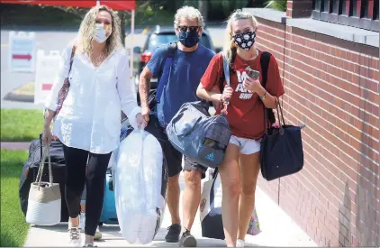  ?? Ned Gerard / Hearst Connecticu­t Media ?? Freshman Michelle DeMotte, of Danbury, arrives at her dormitory on the campus of Sacred Heart University, in Fairfield on Aug. 25.