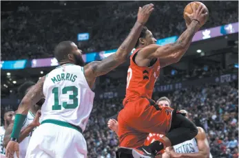  ?? CP PHOTO ?? DeMar DeRozan of the Toronto Raptors slices through traffic to get to the hoop during Tuesday night’s game against the Boston Celtics.