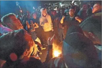  ?? PETE BANNAN — DIGITAL FIRST MEDIA ?? Villanova fans surround a game Monday night. fire on Lancaster Avenue following the National Championsh­ip