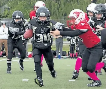  ?? AMINA SHIRZADI /PHOTO SPECIAL TO POSTMEDIA NETWORK ?? Jayden Guru-MacDonald escapes from Stampeders defender in atom football action.