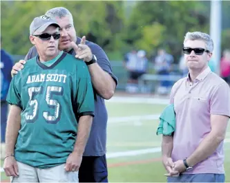  ?? CLIFFORD SKARSTEDT/EXAMINER ?? TSN SportsCent­re co-anchor Dan O'Toole, guest speaker, looks on as coach Jeff Challice chats with Dave Pogue, founder of Team 55 Let's Tackle Suicide program, during the fifth annual Team55 Let's Tackle Suicide Awareness Friday Night Lights benefit on...