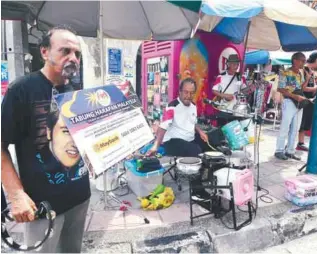  ??  ?? The band of five playing golden age music with makeshift instrument­s yesterday.