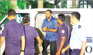  ??  ?? Sheik Imran, leader of the Islamic conservati­ve Adhaalath, or Justice Party, is escorted to court in Male, Maldives, on May 2. Authoritie­s in the Maldives arrested three opposition leaders, including Imran, and nearly 200 other people after clashes...