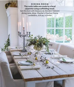  ??  ?? DINING room The rustic table was made by a local carpenter using scaffoldin­g wood. Get this look with Maisons du Monde’s Valmont dining table, £659. Wayfair’s Charlton Home candelabra, £76.99, is similar