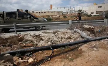  ?? (Reuters) ?? WHERE IS this pipe leading? A water pipe near Hebron last year.