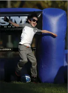  ?? STAFF ARCHIVES ?? Michael Mata celebrates as he scores a goal playing street soccer in the Soccer In Slow Motion inflatable soccer field during the National Night Out event at Saint James Park in a past event.