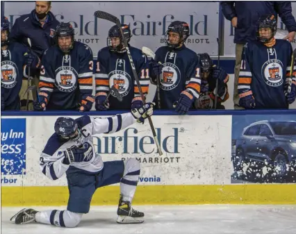  ?? PHOTOS BY TIMOTHY ARRICK — FOR MEDIANEWS GROUP ?? Cranbrook-Kingswood defenseman Leyton Stenman celebrates his third-period goal in front of the Flint Powers Catholic bench, as the Cranes take home a 4-1victory in the first of two MHSAA Division 3semifinal games Friday at USA Hockey Arena in Plymouth.