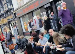  ??  ?? Foodie Friday fans tuck in outside Seven Miles Out in Stockport