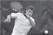  ?? STAFF PHOTO BY DOUG STRICKLAND ?? Signal Mountain’s Thomas Thelen returns a shot to CAK’s Davis Brady during their No. 3 singles match in the Class A/AA team title match Wednesday in Murfreesbo­ro. Thelen won in three sets, but his Eagles lost 4-1.