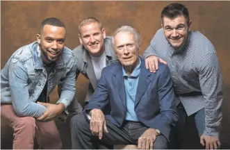  ?? ROBERT HANASHIRO/ USA TODAY ?? Director Clint Eastwood is flanked by real- life heroes Anthony Sadler, left, Spencer Stone and Alek Skarlatos. Eastwood, 87, decided they were the best people to star in “The 15: 17 to Paris.”