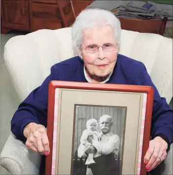 ?? Hearst Connecticu­t Media file photo ?? Ruth Wilson, then 99, with a 1919 photo of her father, Julius Pester, holding her as a baby in Elizabeth, N.J.