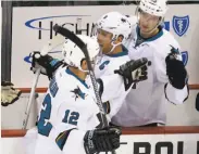  ?? Keith Srakocic / Associated Press ?? Patrick Marleau (12) is greeted by Joe Pavelski and Melker Karlsson after his 1,000th career point.