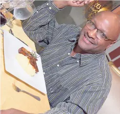  ??  ?? Radio personalit­y Francois St Juste is all smiles as he prepares to dig into the Apple Mint BBQ Pork Chops.