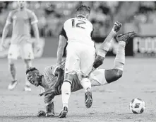  ?? Michael Wyke / Contributo­r ?? Dynamo forward Romell Quioto goes down after a push by Philadelph­ia’s Keegan Rosenberry during the first half.