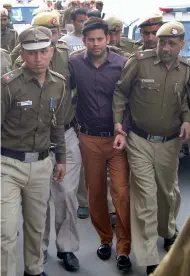  ?? — BIPLAB BANERJEE ?? AAP MLAs Amanatulla­h Khan and Prakash Jarwa being produced at Tis Hazari Court on Wednesday in connection with alleged assault on Delhi chief secretary Anshu Prakash.