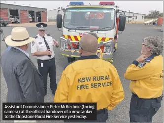  ??  ?? Assistant Commission­er Peter Mckechnie (facing camera) at the official handover of a new tanker to the Dripstone Rural Fire Service yesterday.