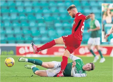  ??  ?? Hibernian’s Kevin Nisbet feels the pain as he tackles St Mirren’s Marcus Fraser