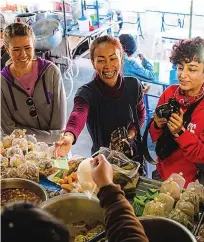  ??  ?? Stall wonders: Travellers take in lively markets on the tour