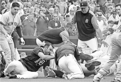  ?? RICK OSENTOSKI, USA TODAY SPORTS ?? Tigers first baseman Miguel Cabrera, bottom right, was not pleased with the seven-game suspension he received for his role in a brawl with the Yankees on Aug. 24.