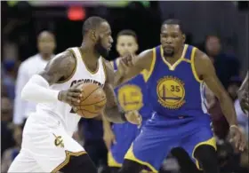  ?? TONY DEJAK — THE ASSOCIATED PRESS ?? The Cavaliers’ LeBron James and the Warriors Kevin Durant will square off again on Christmas Day when Cleveland plays Golden State as part of the NBA’s star-studded holiday lineup.