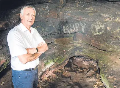  ?? Pictures: Steve MacDougall. ?? Sad state: Councillor Tom Adams inspects the damage done by vandals and, below, passes bags of abandoned litter as he visits the caves.