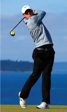  ?? GETTY ?? Rory McIlroy watches a tee shot during yesterday’s practice round