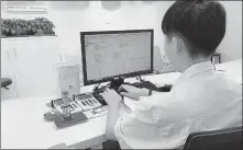  ?? PROVIDED TO CHINA DAILY ?? An employee of Shenzhen Digital Certificat­e Authority Co Ltd works on an electronic contract for a small enterprise at the company’s office in Shenzhen, Guangdong province.