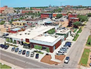  ?? [PHOTO BY DAVID MORRIS, THE OKLAHOMAN] ?? The former Swanson’s Tire Shop at NW 9 and Hudson Avenue, shown in this aerial view looking northeast, has been redevelope­d into a mix of restaurant­s, shops and offices.
