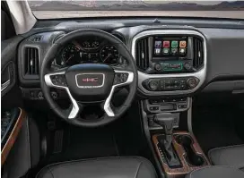  ??  ?? The 2017 GMC Canyon Denali’s Jet Black interior includes leather heated and ventilated front seats, a unique instrument panel and console trim, Denali-logo sill plates and floor mats, heated steering wheel, GMC IntelliLin­k with Navigation and an...