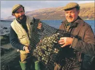  ??  ?? The early days – Andy Lane and Johnny Noble examine their oysters on the shores of Loch Fyne.