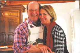  ?? PHOTO COURTESY OF SARA NATION ?? Austin Tilghman and Sara Nation get cozy in their kitchen in Castle Rock, Colorado, where they are blending their lives and furnishing­s in a new house.