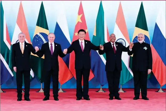  ??  ?? (L-R) Brazilian President Michel Temer, Russian President Vladimir Putin, Chinese President Xi Jinping, South African President Jacob Zuma and Indian Prime Minister Narendra Modi pose for a group photo during the BRICS Summit at the Xiamen...