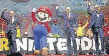  ?? BLOOMBERG ?? Thierry Coup, senior VP of Universal Creative (extreme left), with an actor dressed as Mario at Universal Studios Japan.