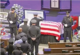  ??  ?? Police officers pay their respects at the funeral service for Senior Corporal Lorne Ahrens at Prestonwoo­d Baptist Church in Plano, Texas, on Wednesday. —