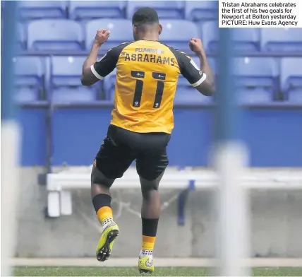  ??  ?? Tristan Abrahams celebrates the first of his two goals for Newport at Bolton yesterday PICTURE: Huw Evans Agency