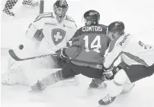  ??  ?? Canada’s Maxine Comtois charges the crease against Switzerlan­d goalie Philip Wuthrich during the first period in Hamilton, Ont., on Friday.