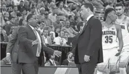  ?? MIKE CHRISTY/ARIZONA DAILY STAR ?? Arizona assistant coach Emanuel "Book" Richardson, left, and head coach Sean Miller bring the team in for a timeout in the first round of the NCAA Tournament on March 16, 2017.