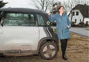  ?? — ap ?? nissen standing next to an electric car in Sprakebuel­l. She and her husband invested in a wind farm more than 20 years ago and their investment has paid off handsomely.