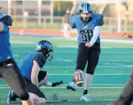 ?? ALLEN CUNNINGHAM/DAILY SOUTHTOWN ?? Lincoln-Way East’s Michael Kozak kicks an extra point during Friday’s game against Lincoln-Way Central.